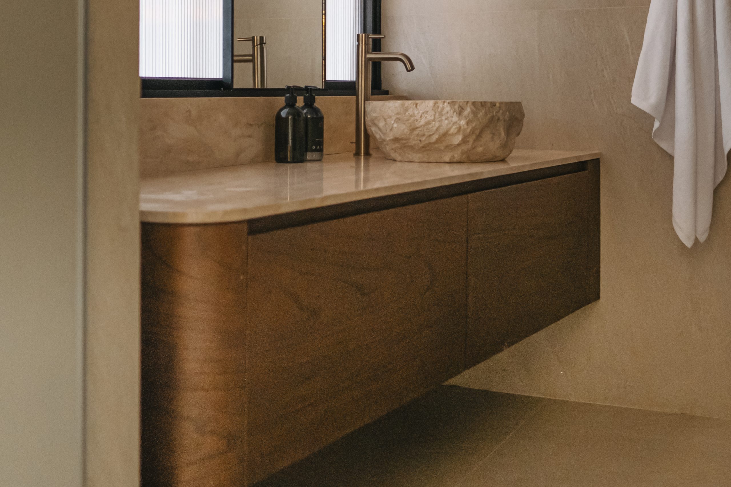 Close-up of the bespoke wooden bathroom vanity at Elison aparthotel in Bali