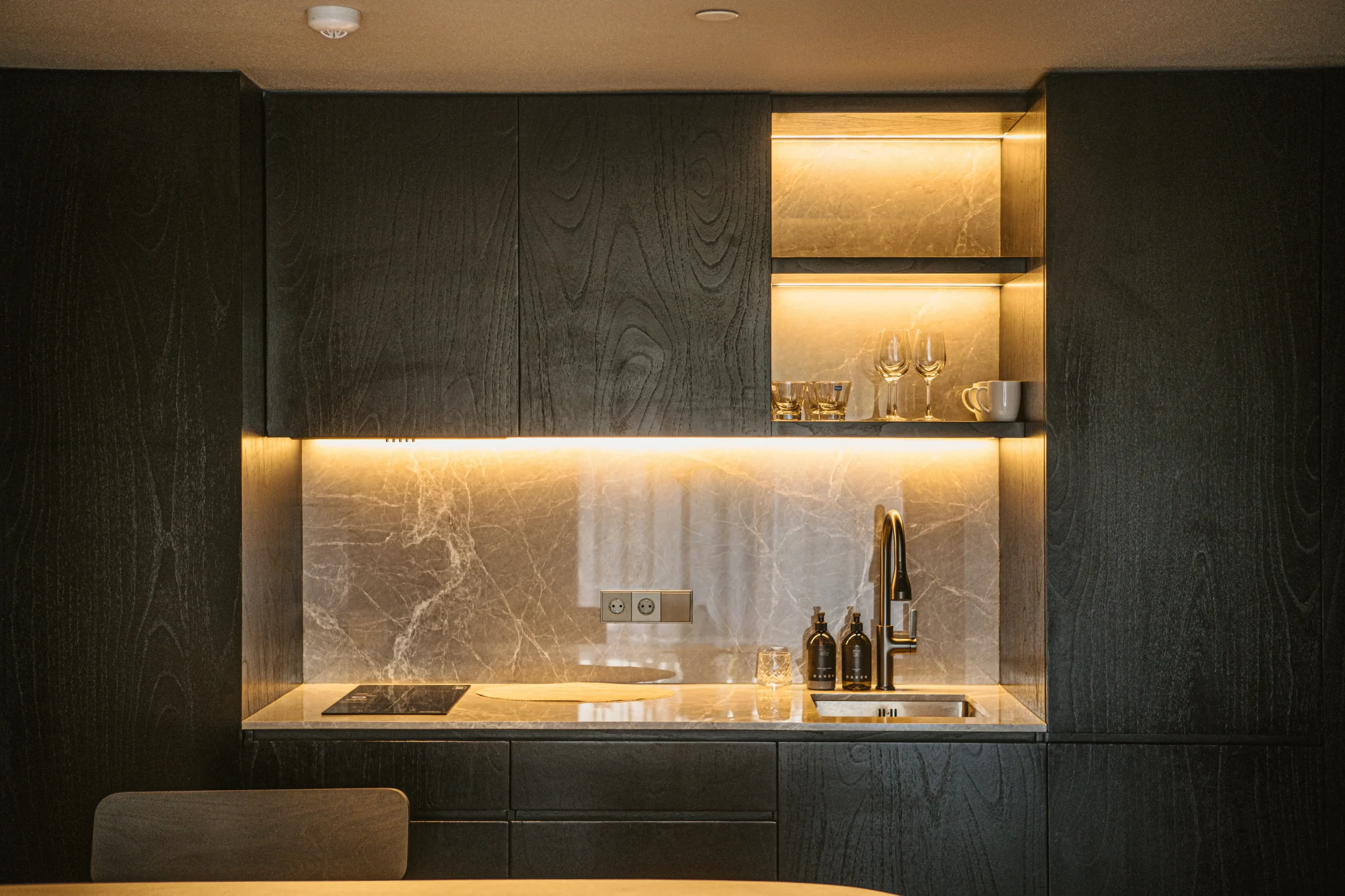 Overall bespoke built-in kitchen in dark tone at Elison aparthotel in Bali