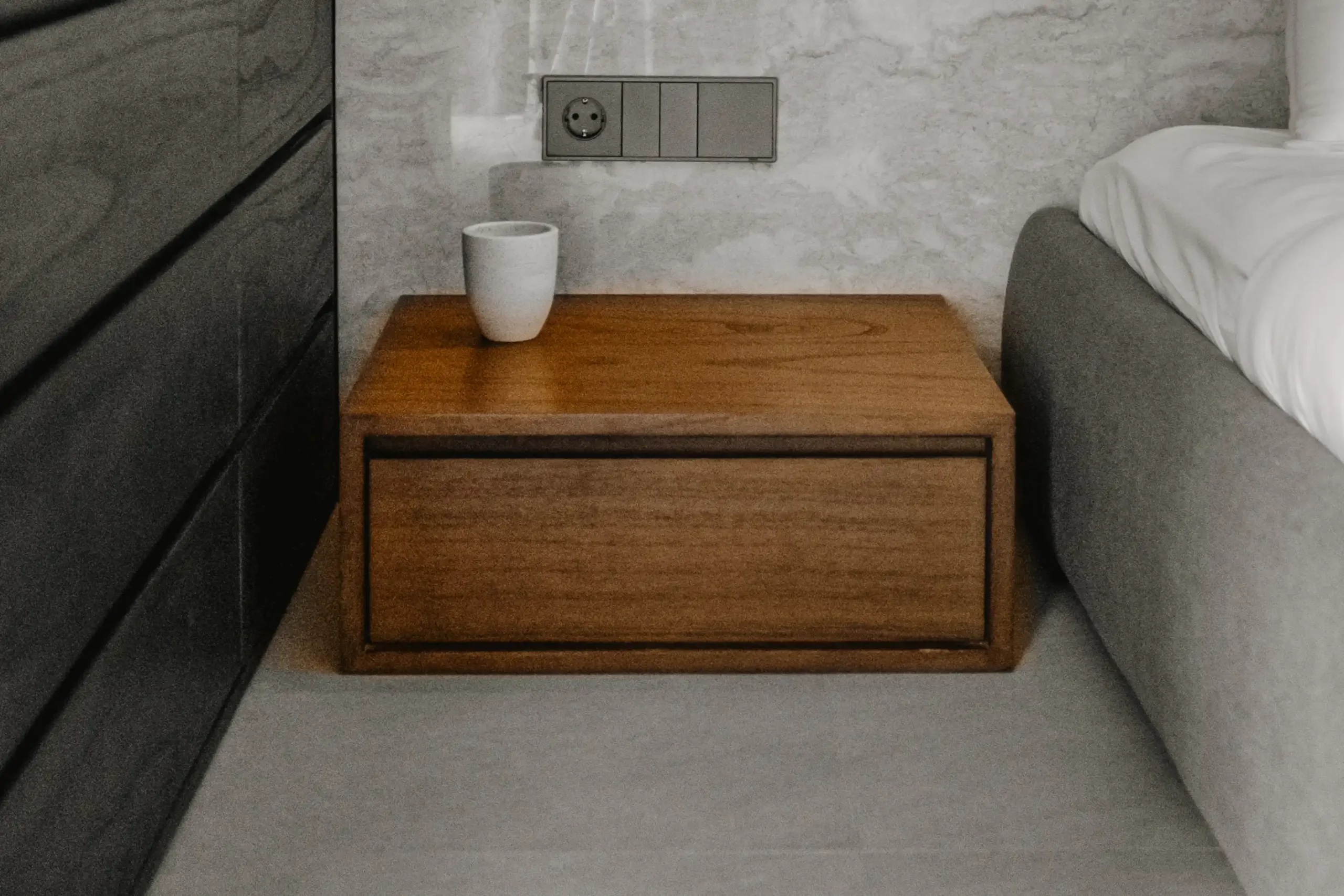 Close up of bespoke wooden bedside table in Elison aparthotel room in Bali