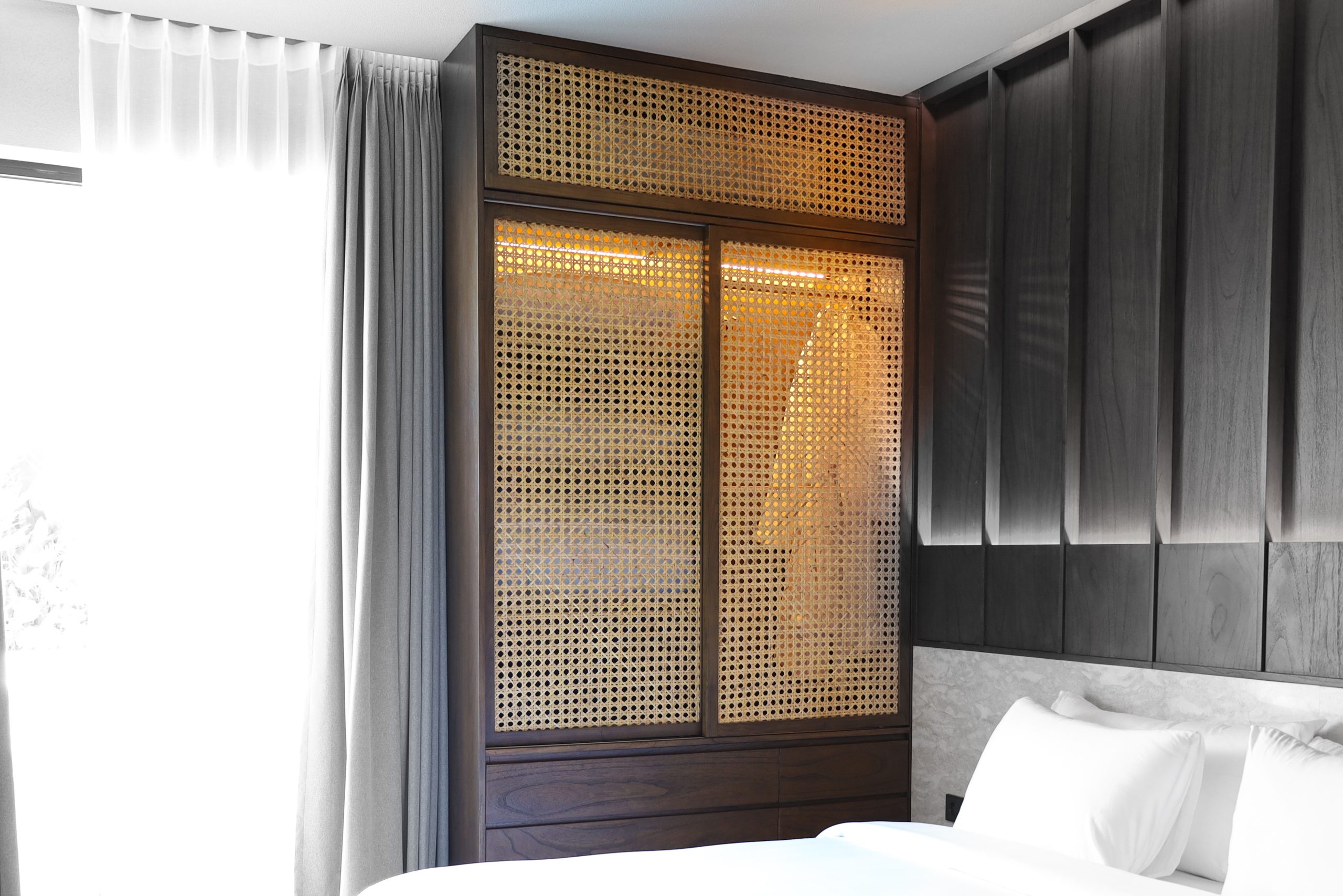 Bespoke wardrobe made of Java Oak and rattan at Elison aparthotel bedroom