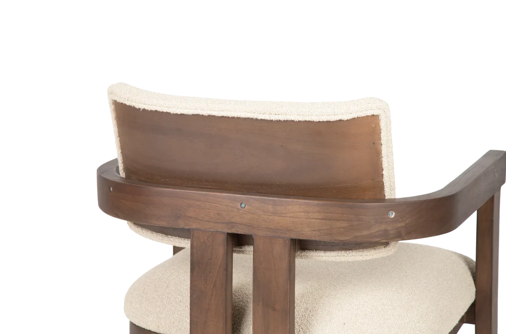 Close up of DOM armchair backrest made of dark teak with cream upholstered seating viewed from the back